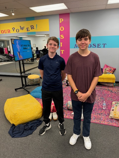 Two boys happily standing together at Fearless Focus.The boys program focused on social-emotional growth.